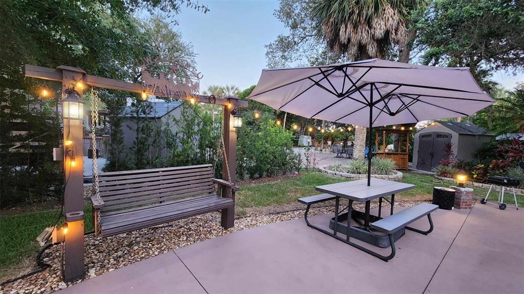 a view of a backyard with sitting area and furniture