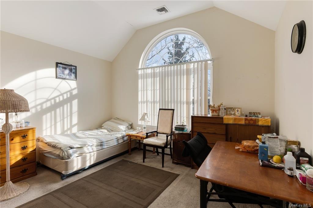 a bedroom with furniture and a window