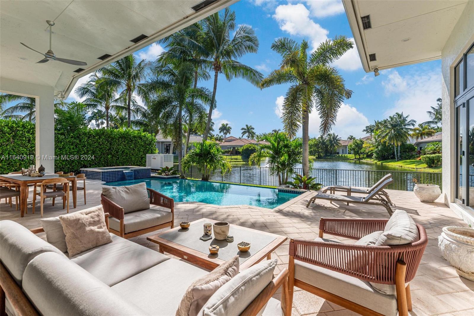 a view of a patio with couches potted plants and a palm tree