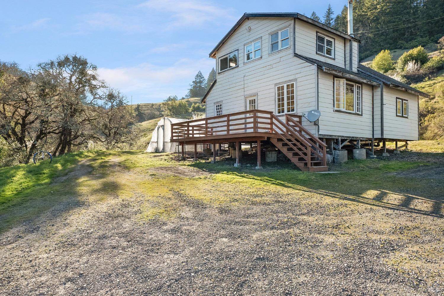 a view of a house with a yard and sitting area