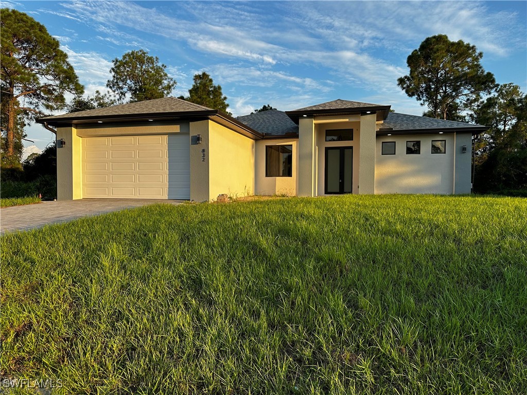 a front view of a house with a garden