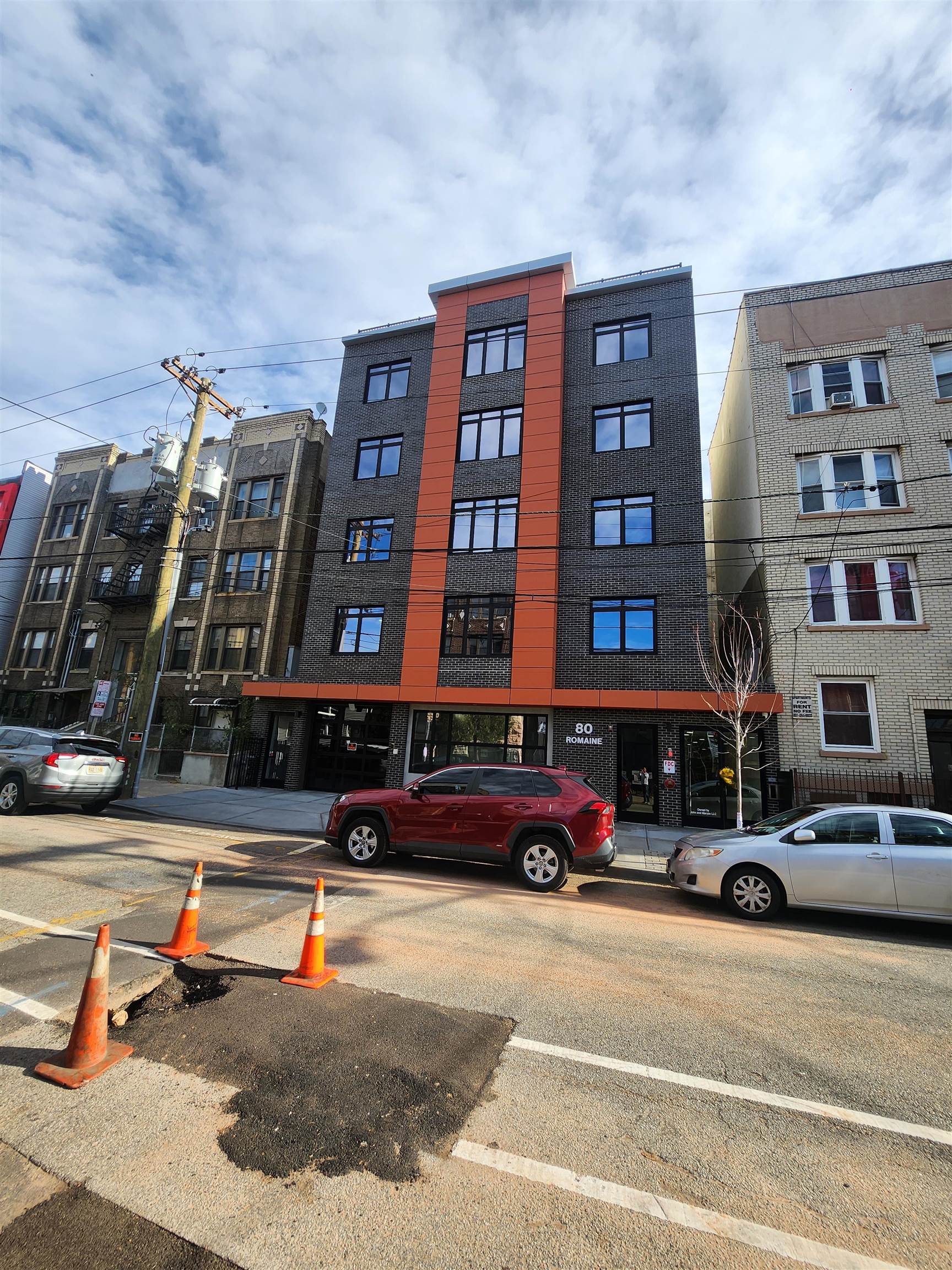 a buildings with car parked in front of it