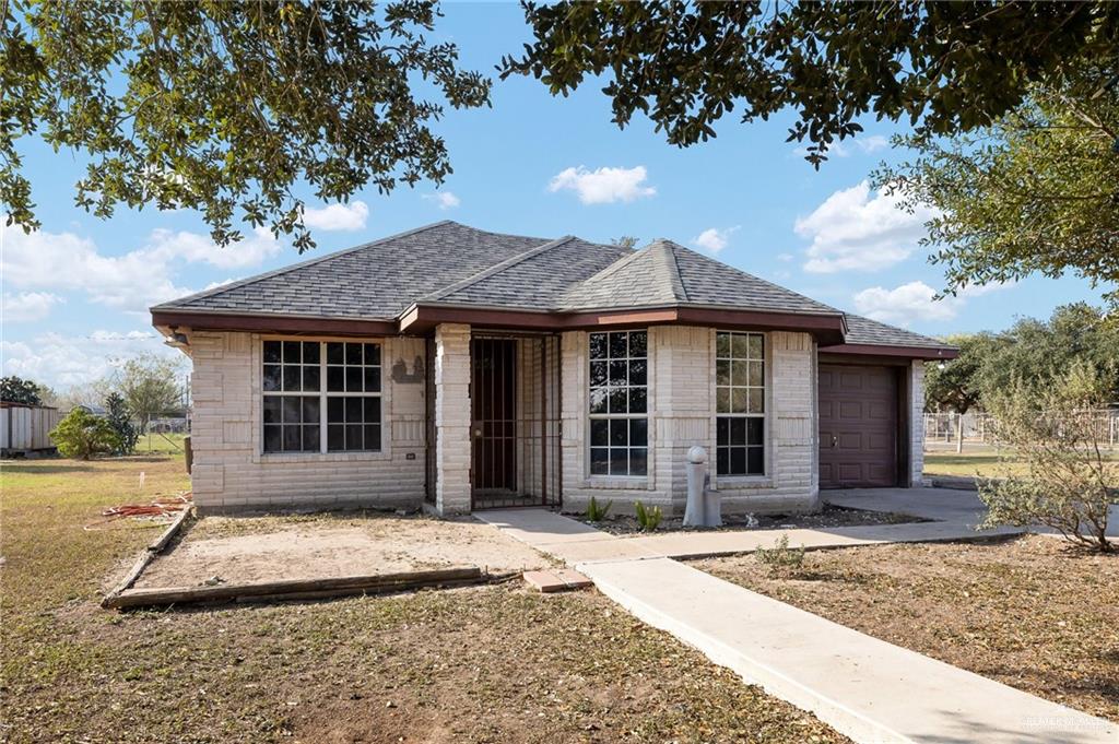 View of front facade with a front lawn and a garage