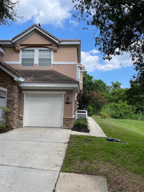 a front view of a house with a yard and garage