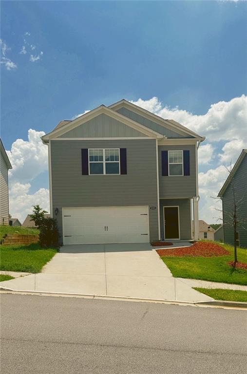 a front view of a house with a yard