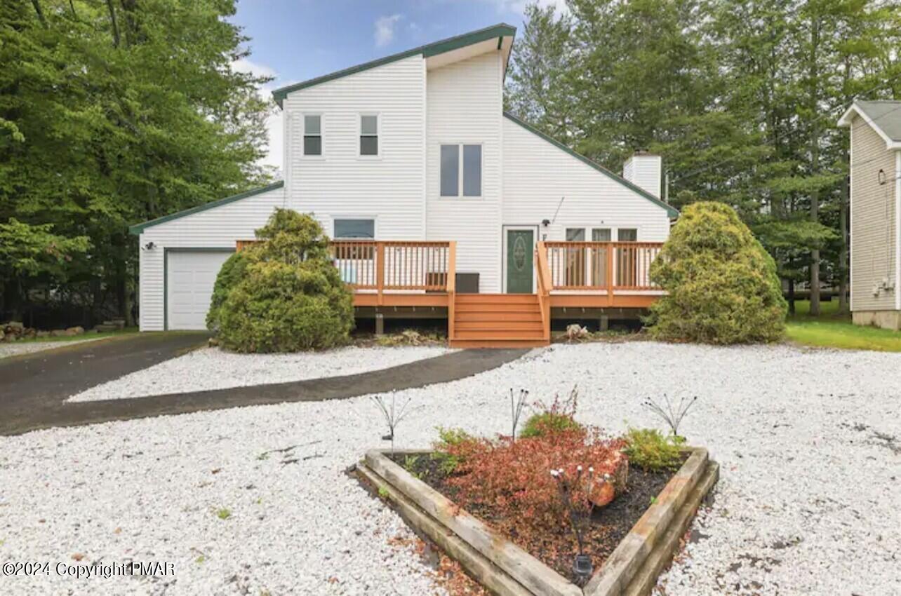 a front view of a house with a yard and a garage