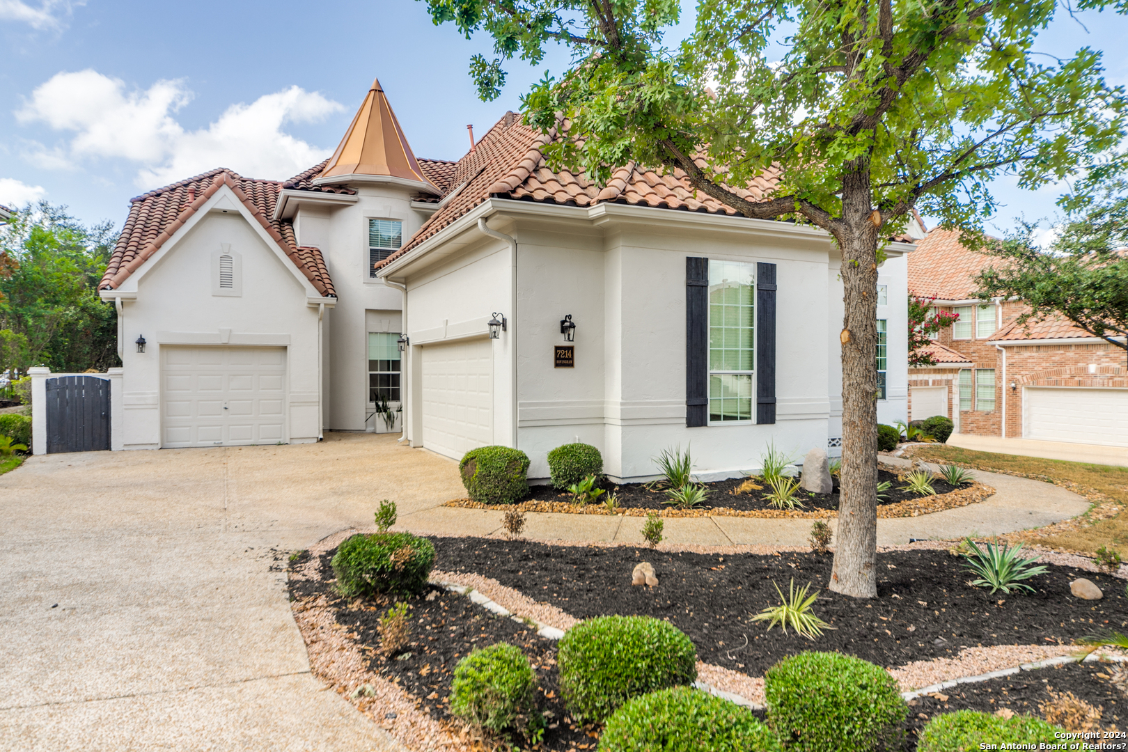 a front view of a house with garden