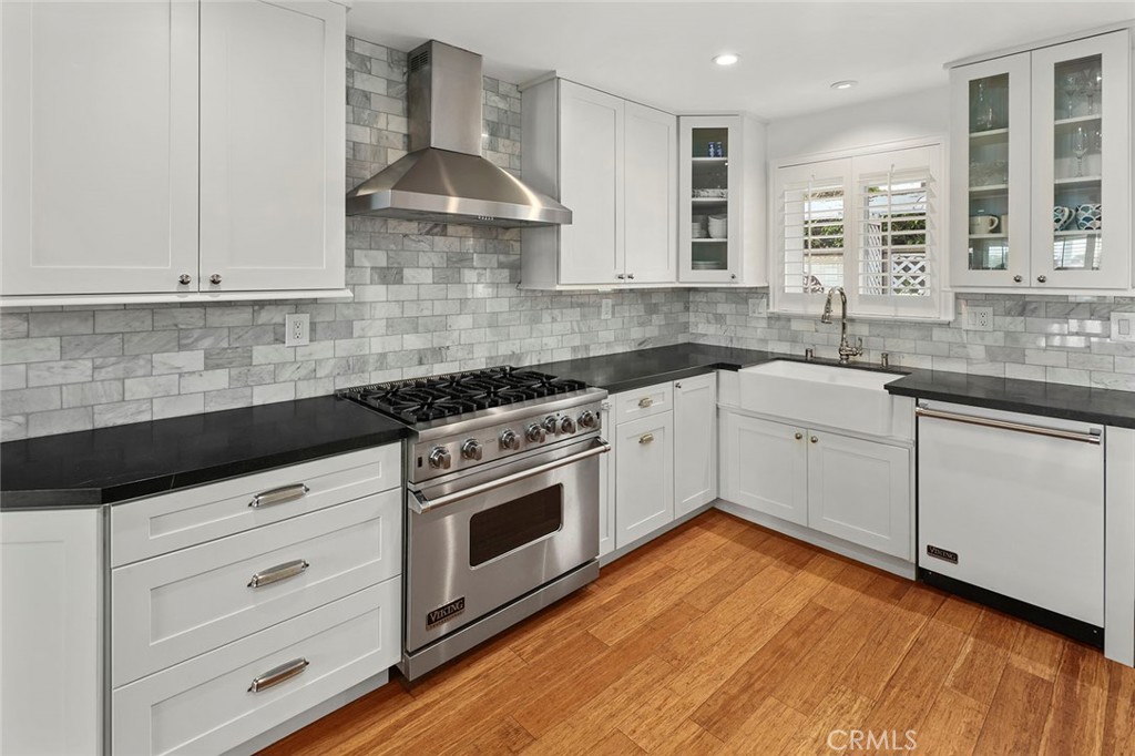 a kitchen with stainless steel appliances granite countertop a sink stove and cabinets