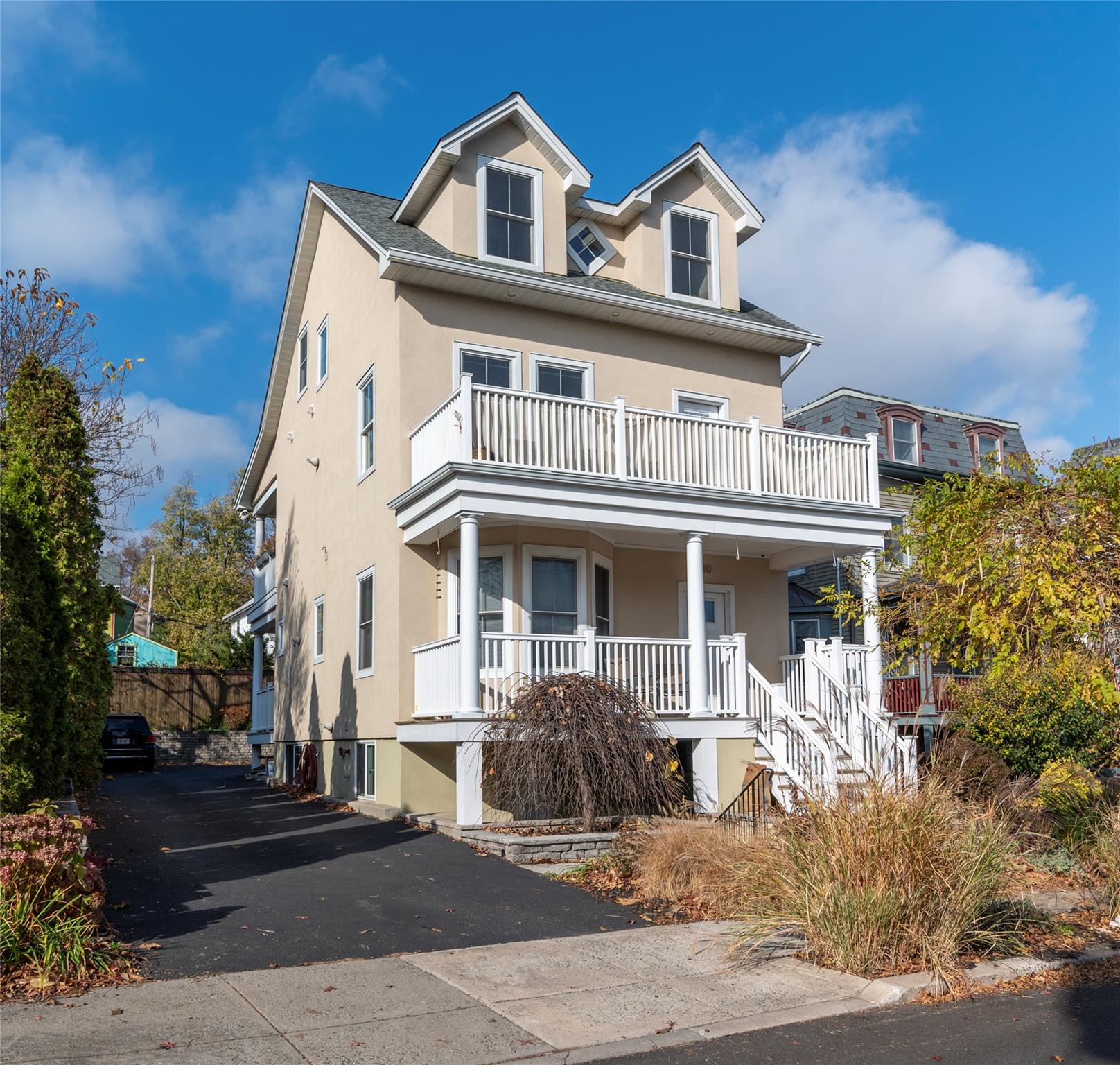 View of front of property with a balcony and a porch