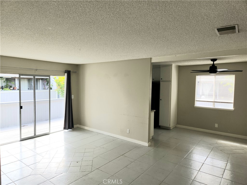 an empty room with windows and closet