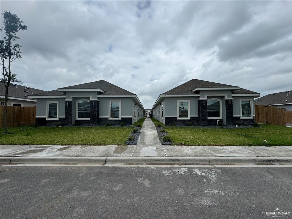 a front view of house with yard and green space