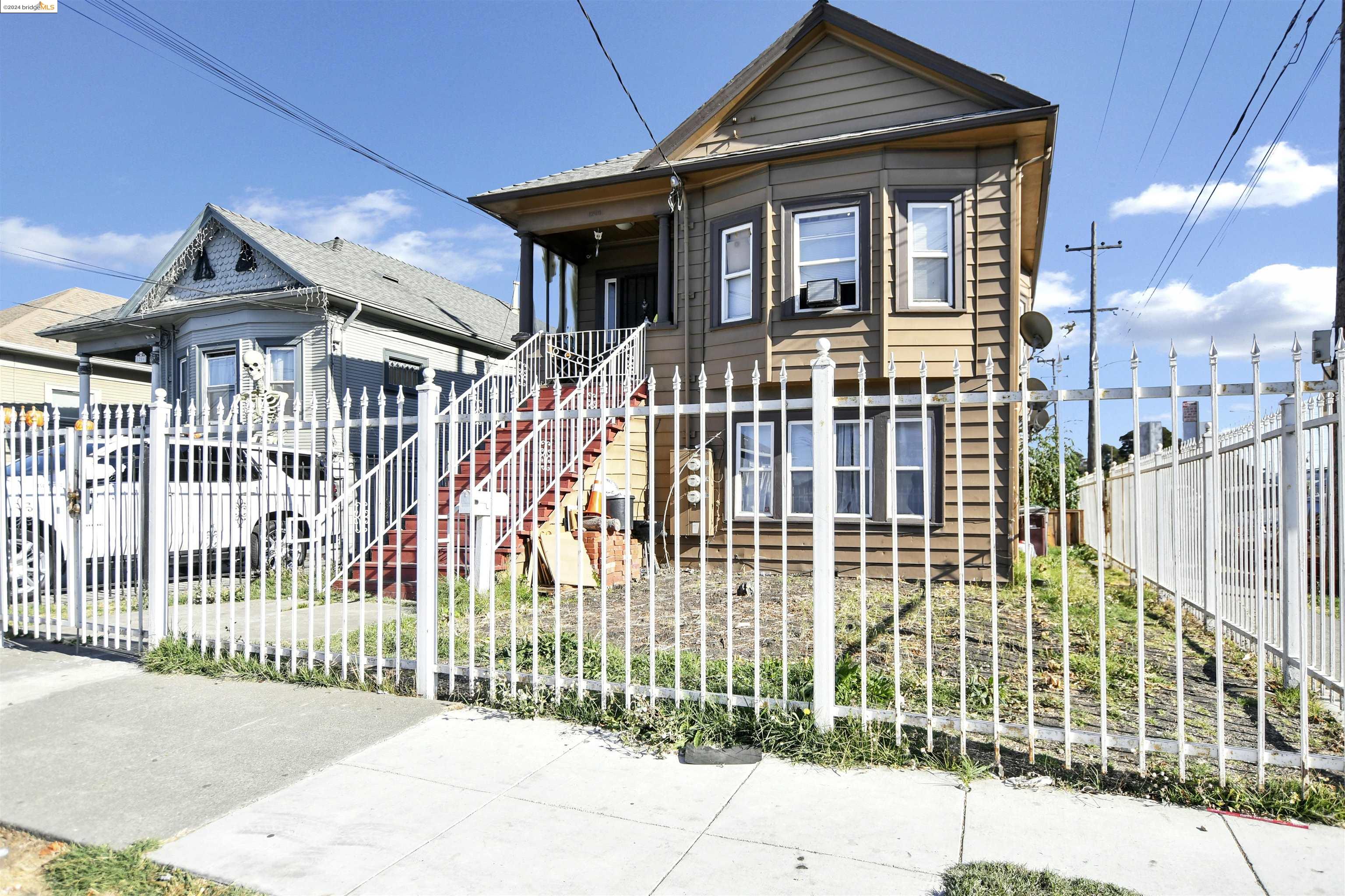 a front view of a house with a iron gate