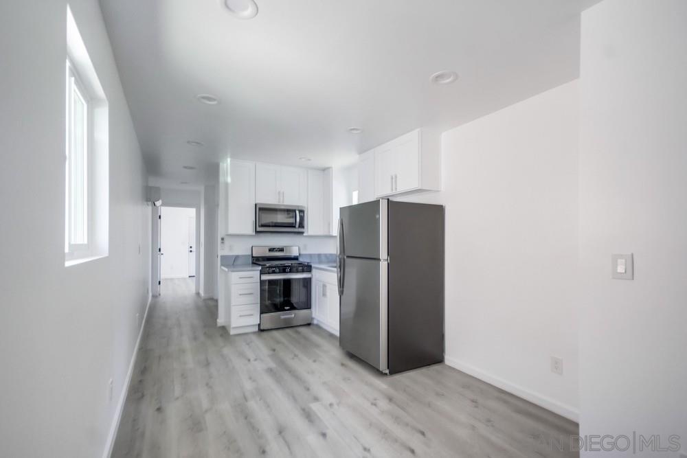 a kitchen with stainless steel appliances a refrigerator and a stove top oven