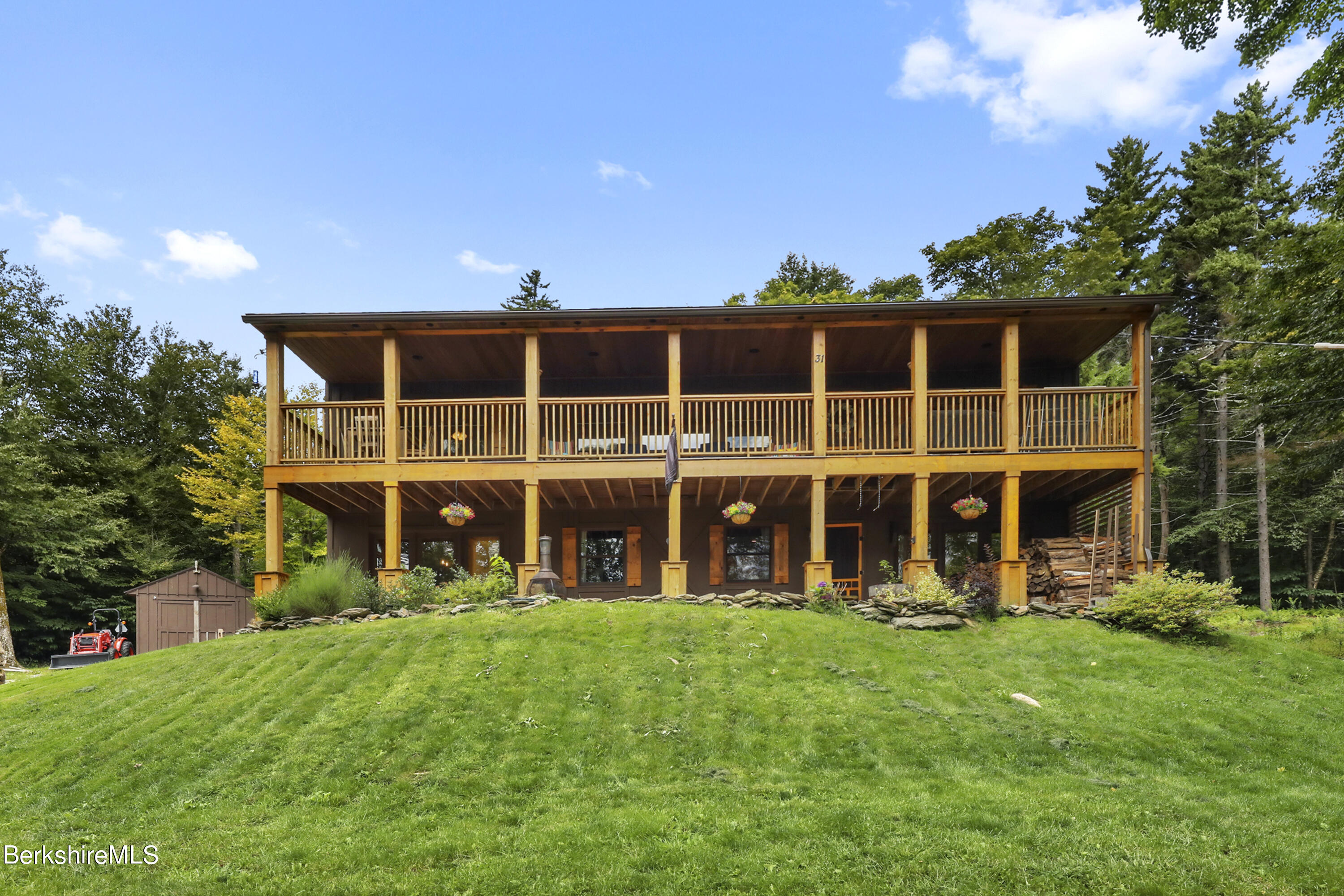 a big yard with large trees and plants