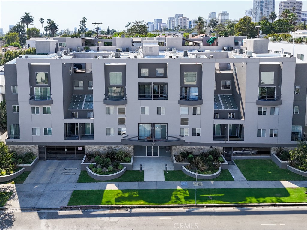 a front view of a residential apartment building with a yard