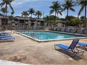 a view of swimming pool with outdoor seating and a patio