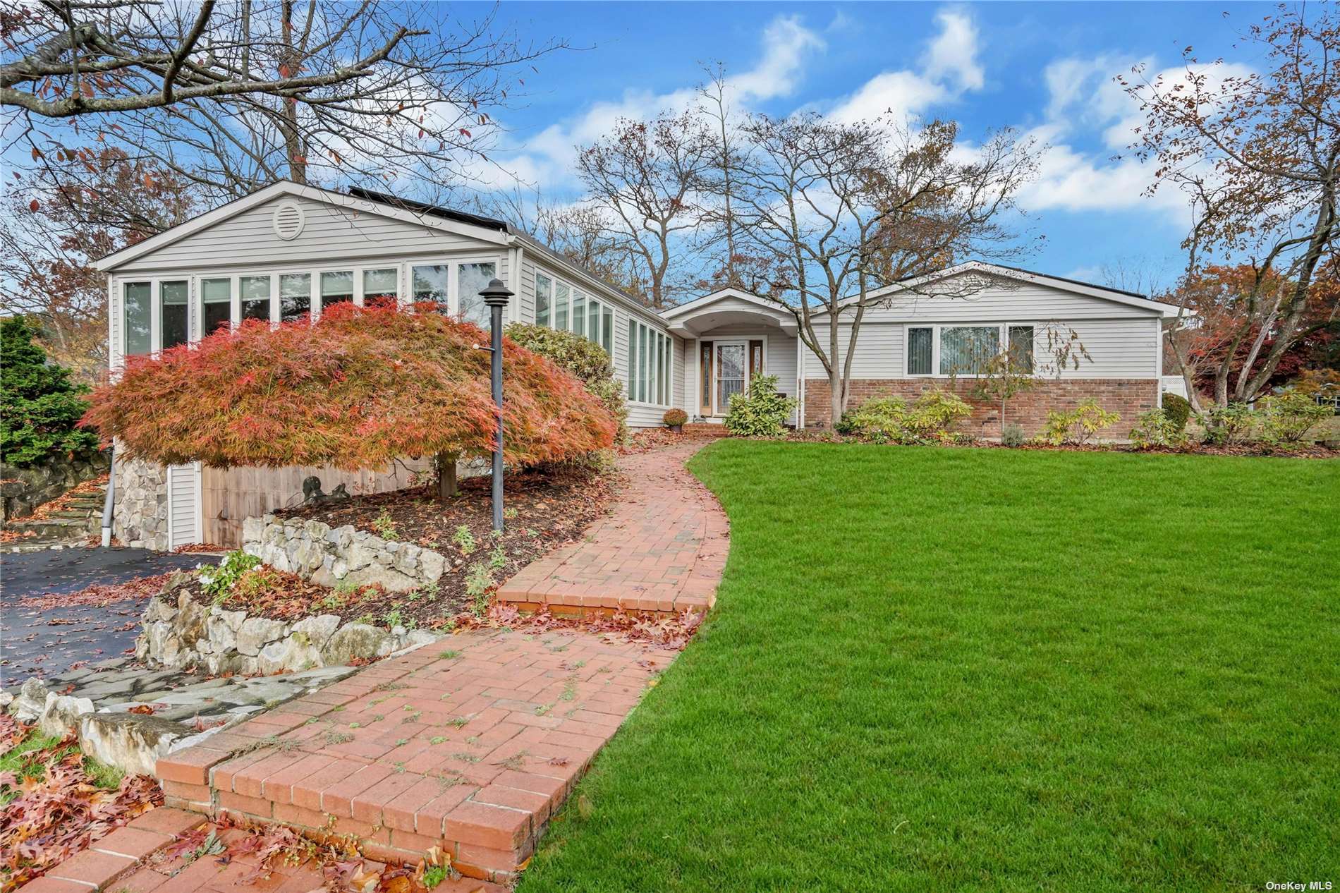 a front view of a house with a garden