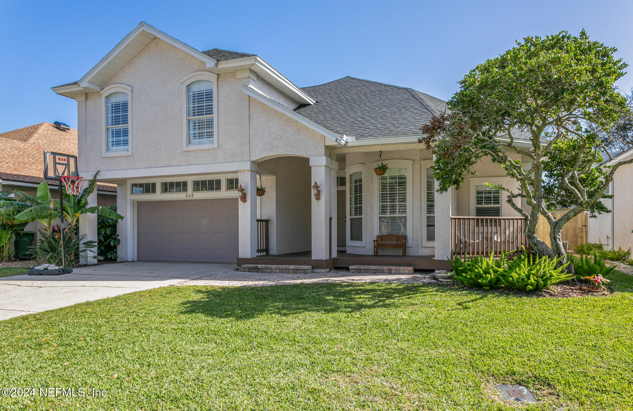 a front view of a house with a yard and seating space