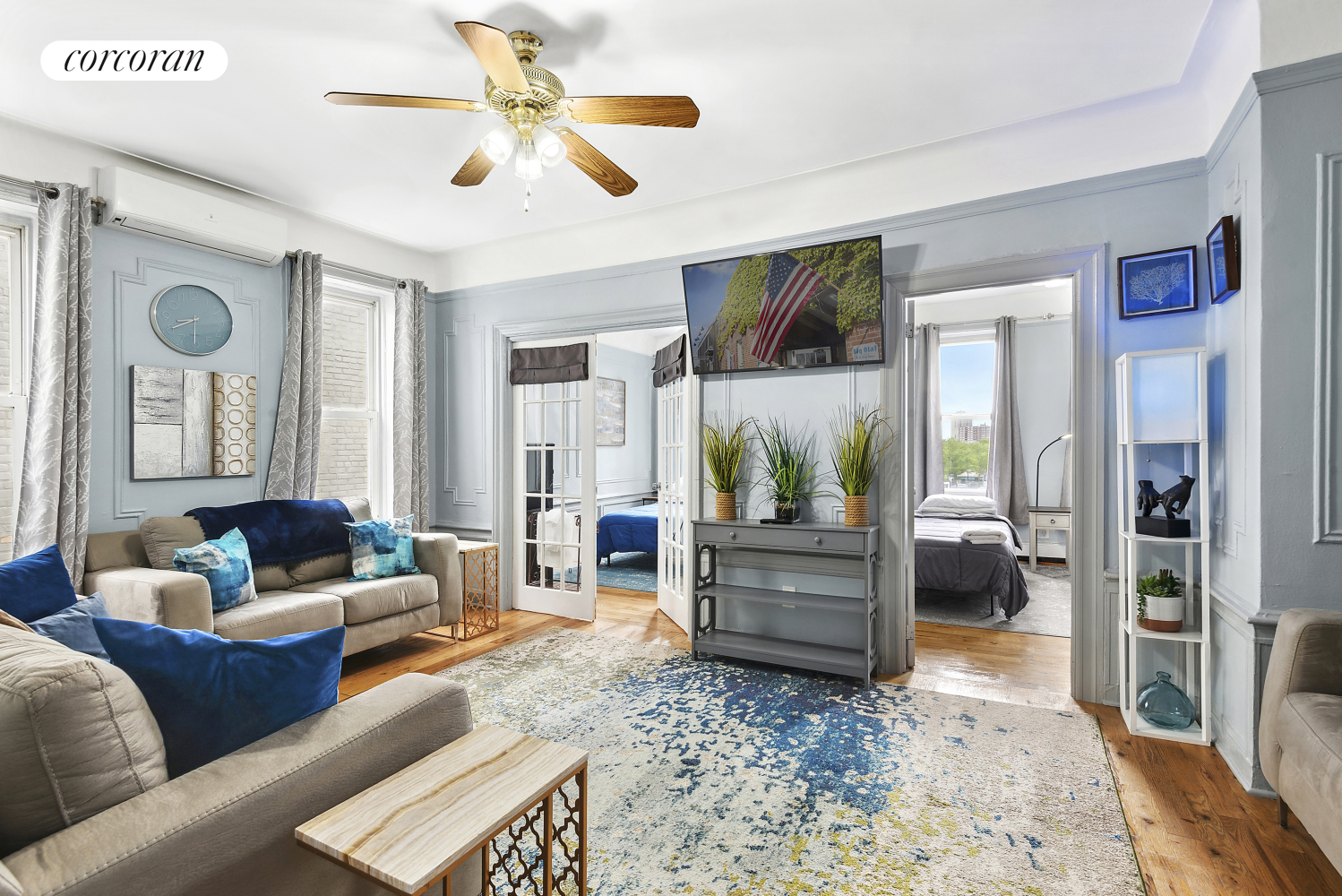 a living room with furniture and a chandelier