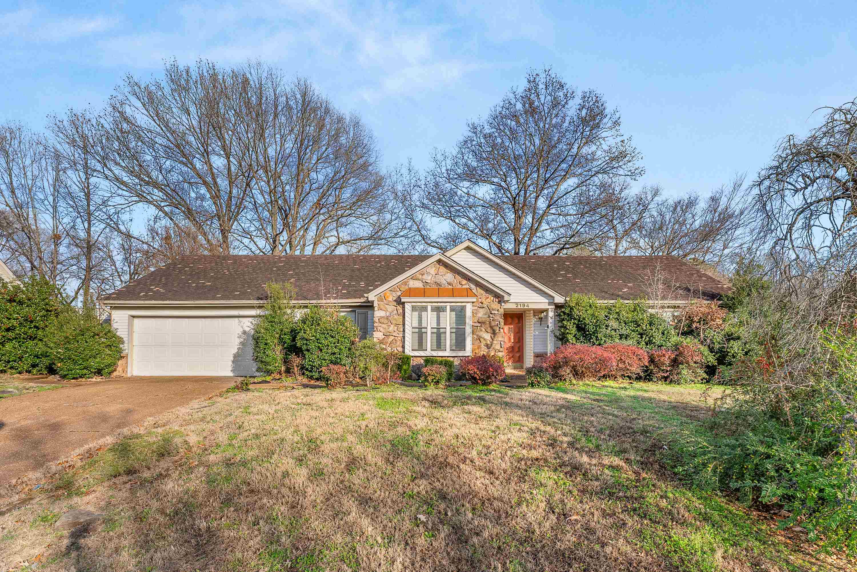 Ranch-style house with a garage and a front yard