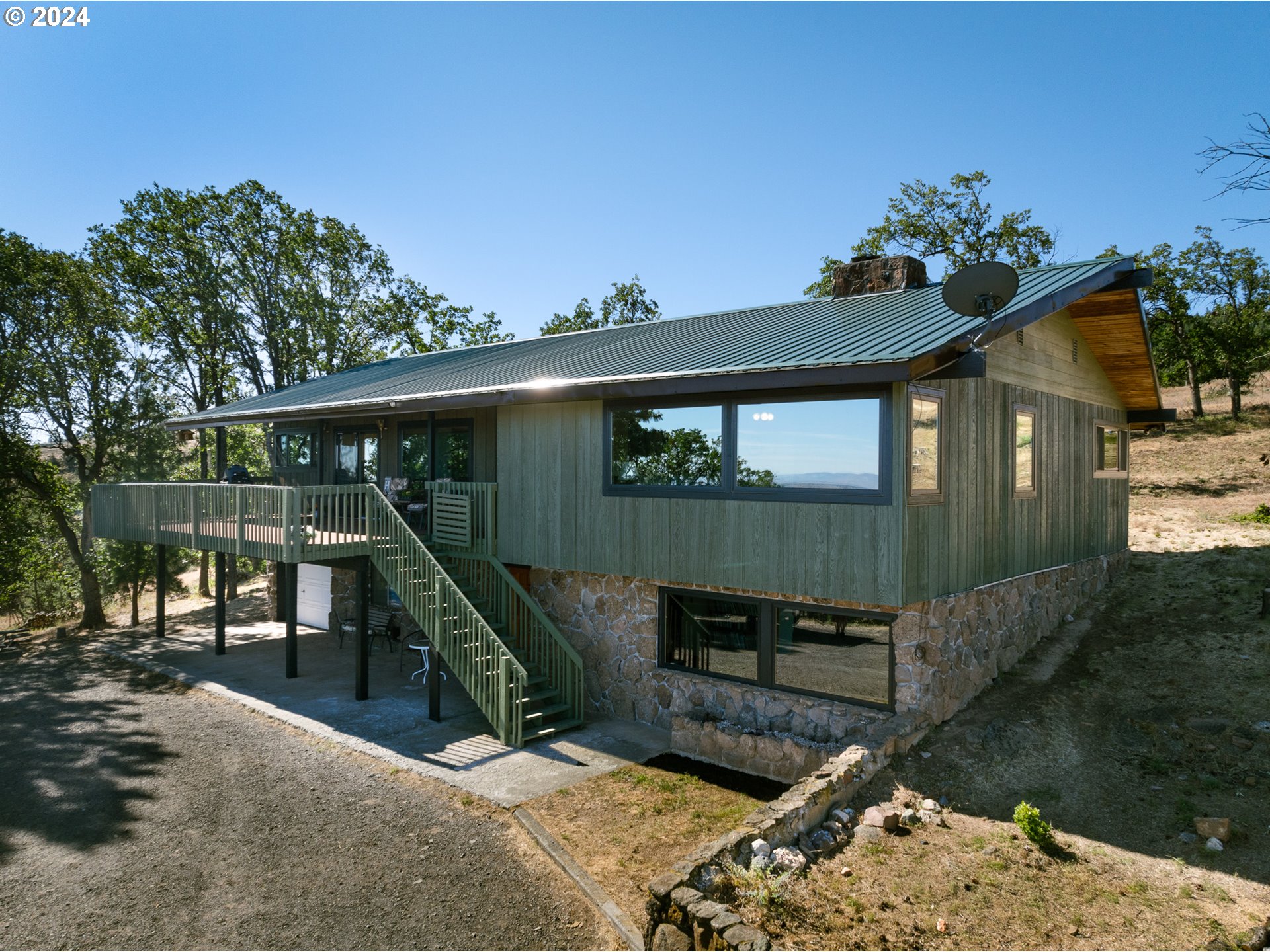 a view of a house with a wooden deck