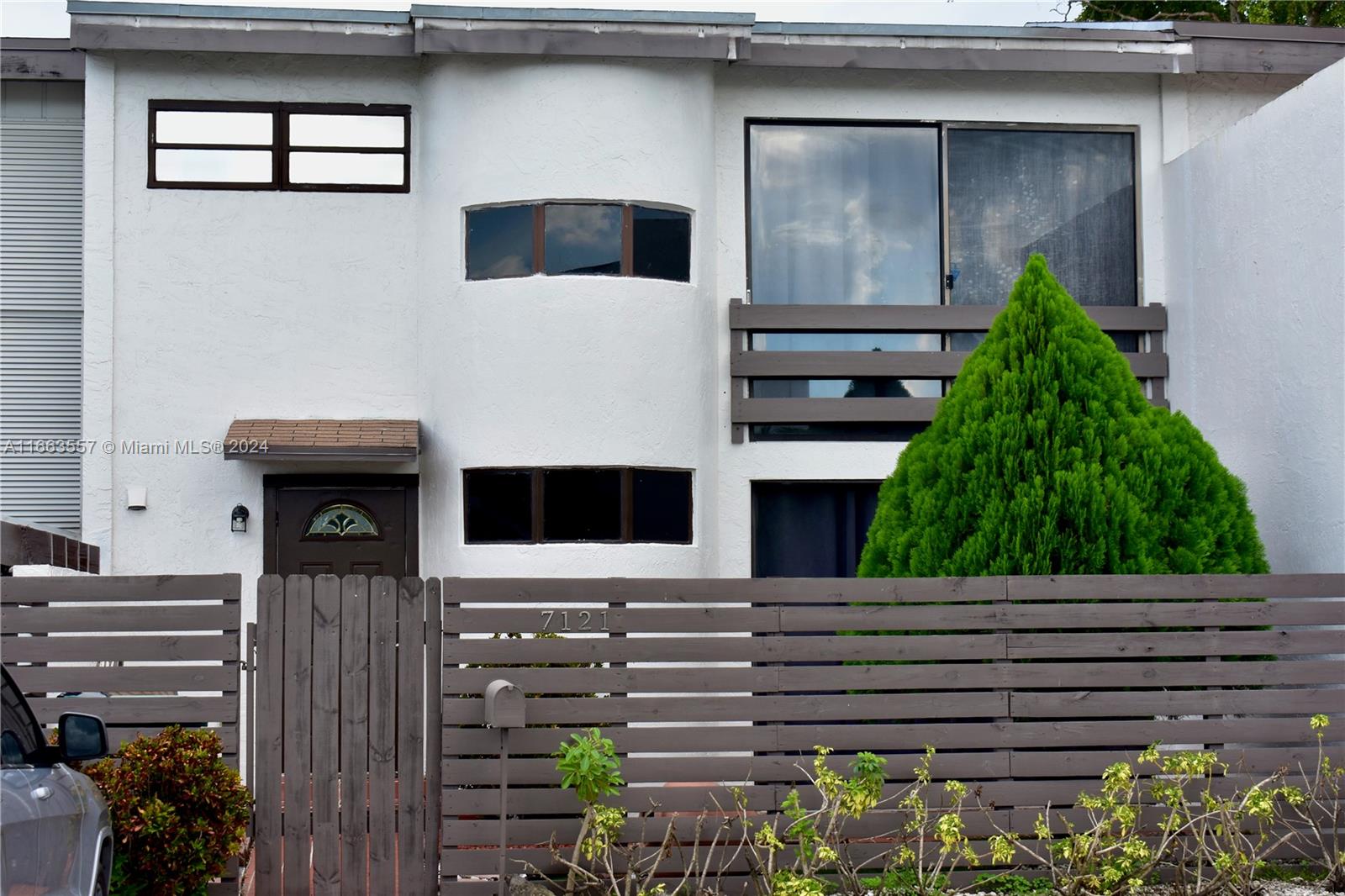 a front view of a house with garden