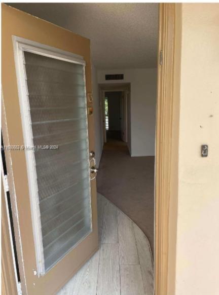 a view of a bathroom from a hallway