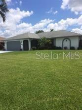 a front view of a house with a big yard