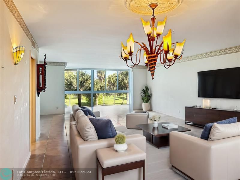 a living room with furniture fireplace and a chandelier