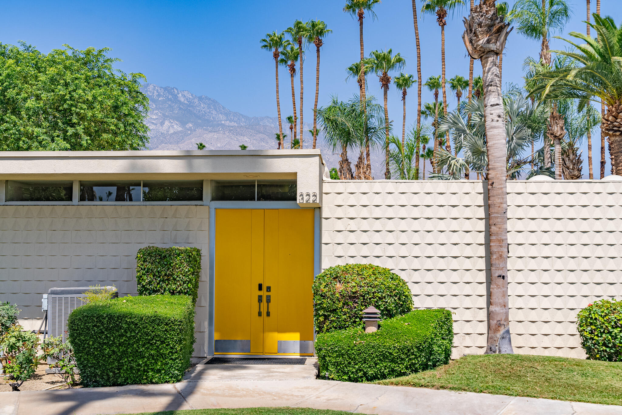 a view of a house with fountain in front of it