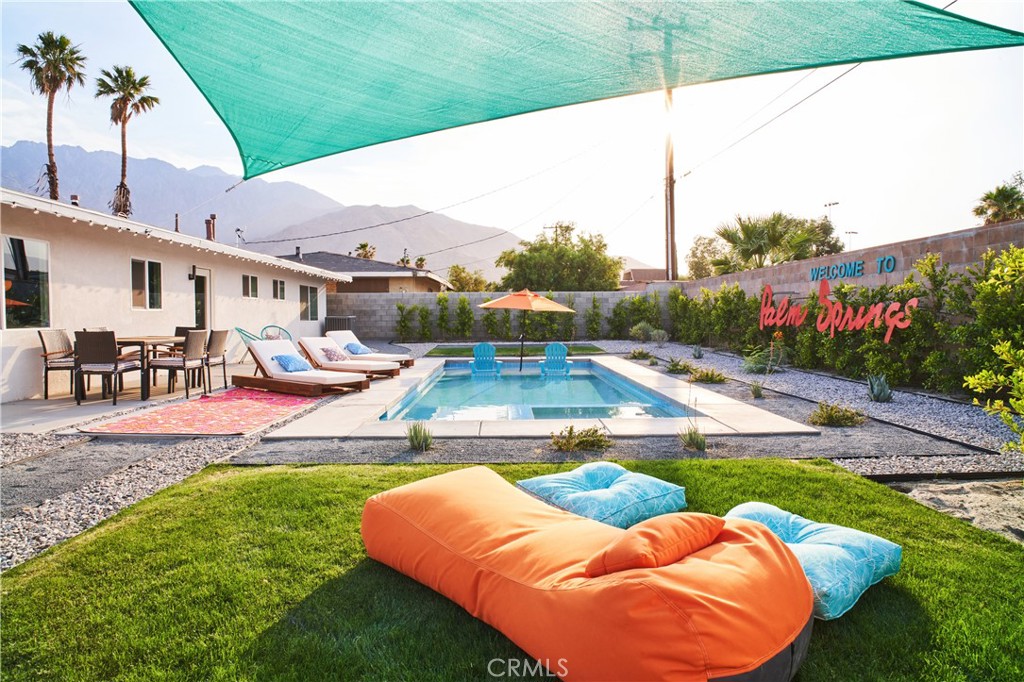 a view of swimming pool with outdoor seating