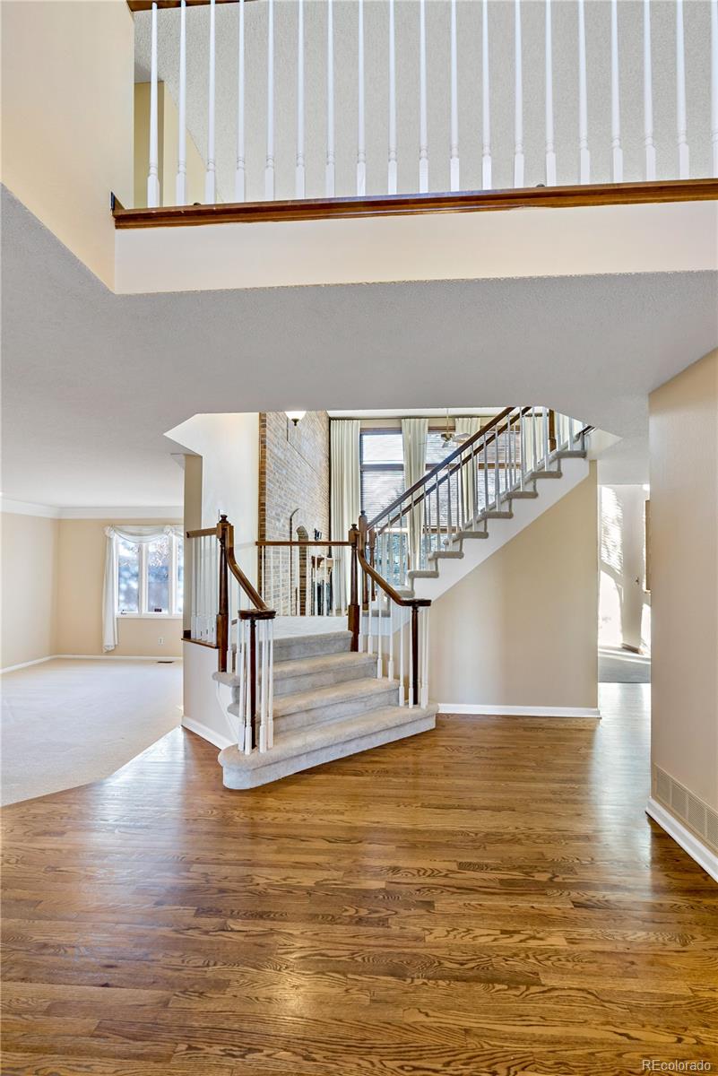 a view of entryway and hall with wooden floor