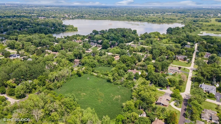 an aerial view of a houses with a lake view