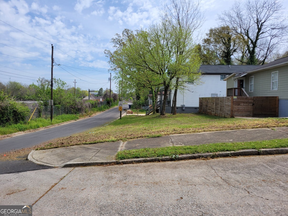 a view of a house with a yard and a fountain