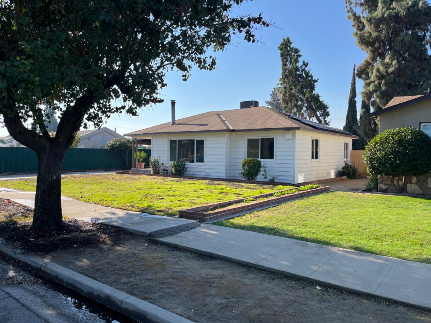 a view of a house with swimming pool and a yard