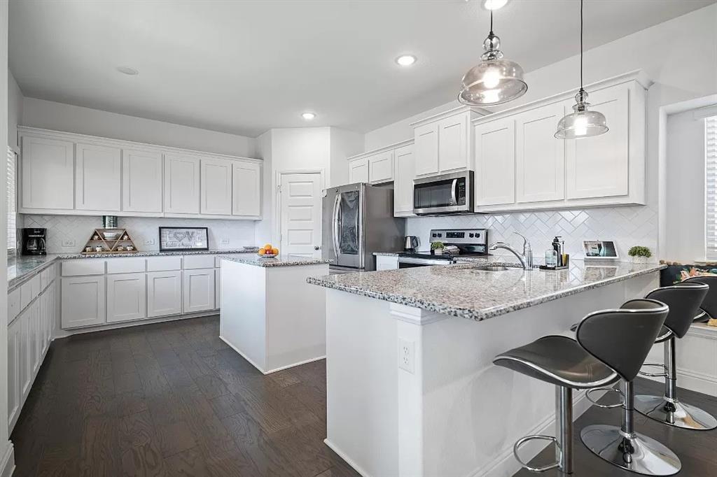 a kitchen with cabinets a sink and appliances