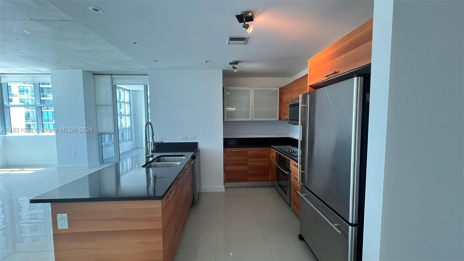 a kitchen with a refrigerator and sink