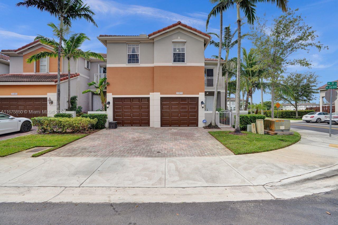 a front view of a house with a yard and garage