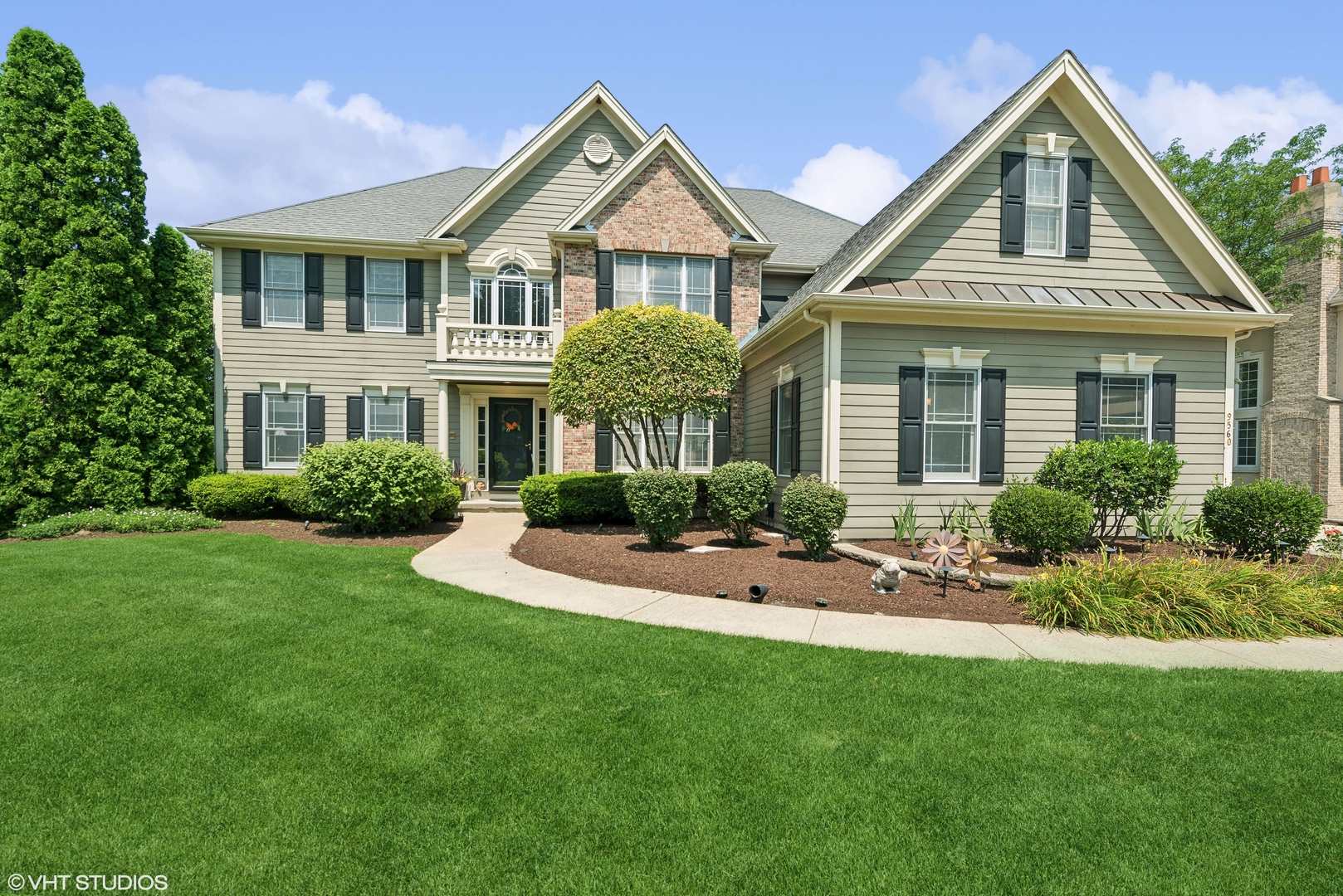 a front view of a house with a yard and porch