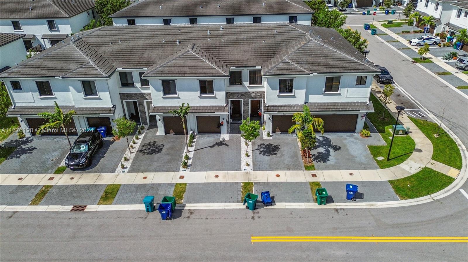 an aerial view of a house with a swimming pool and outdoor seating