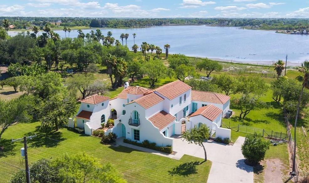 an aerial view of a house with a lake view