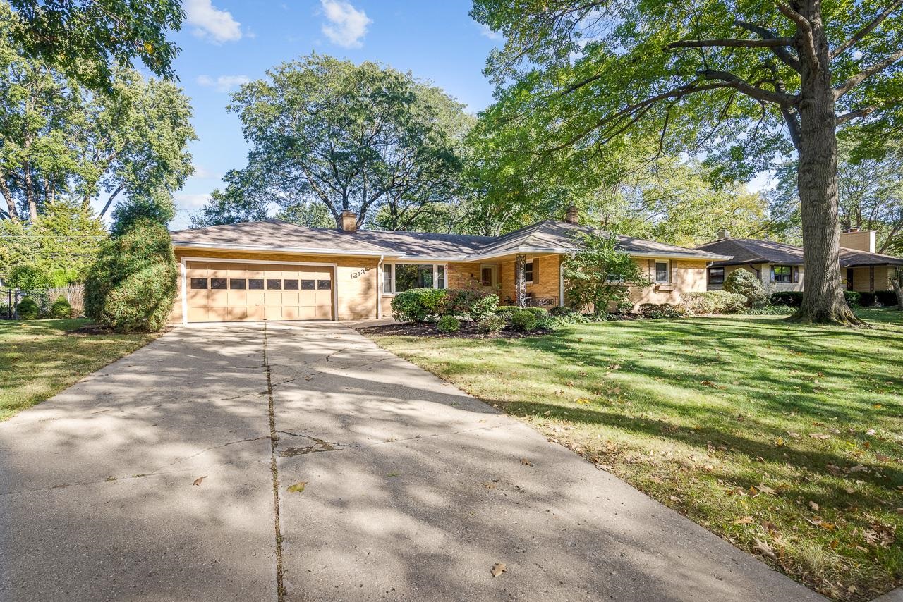 a view of house with outdoor space and trees around