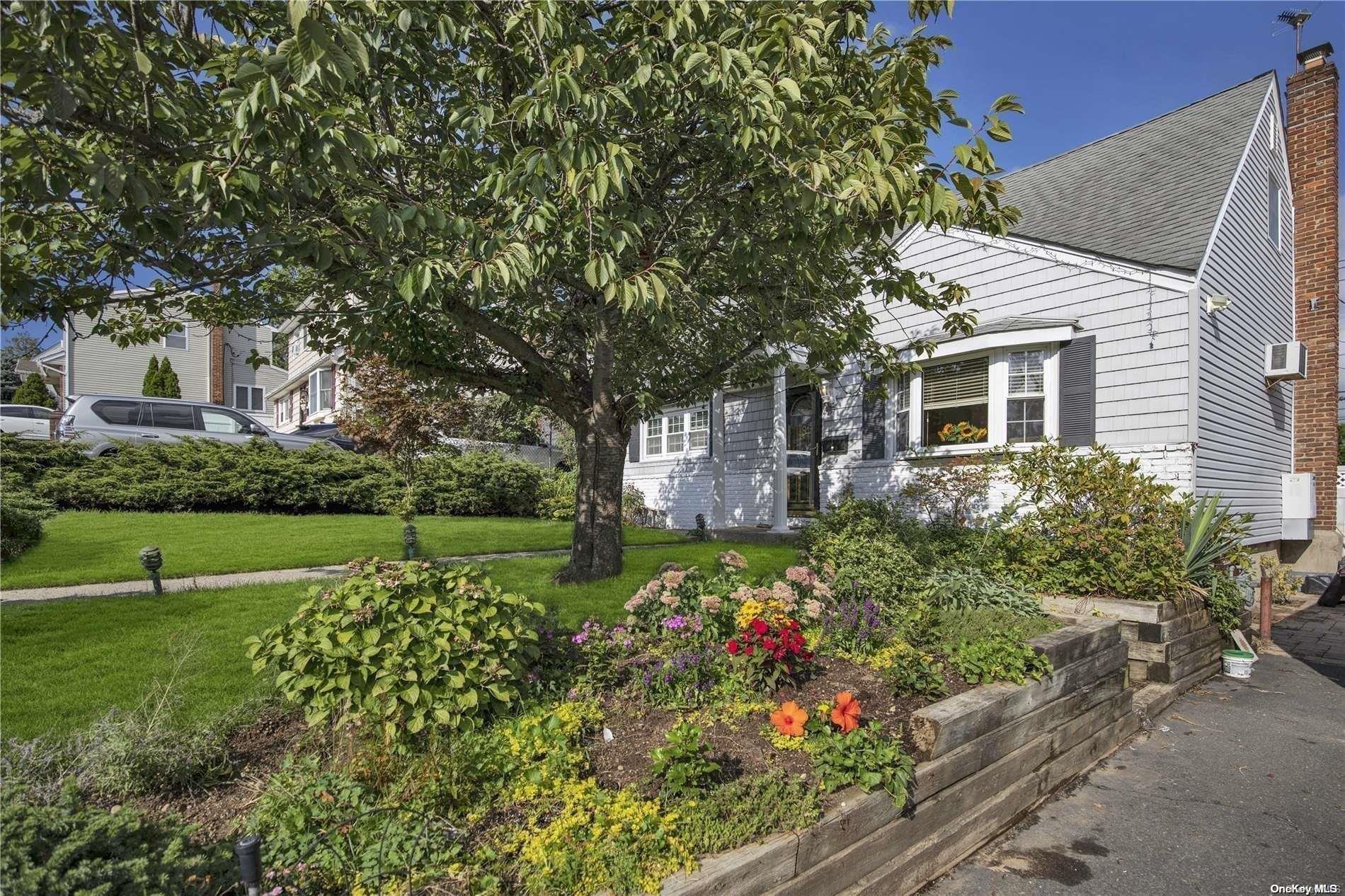 a view of garden with flowers and trees