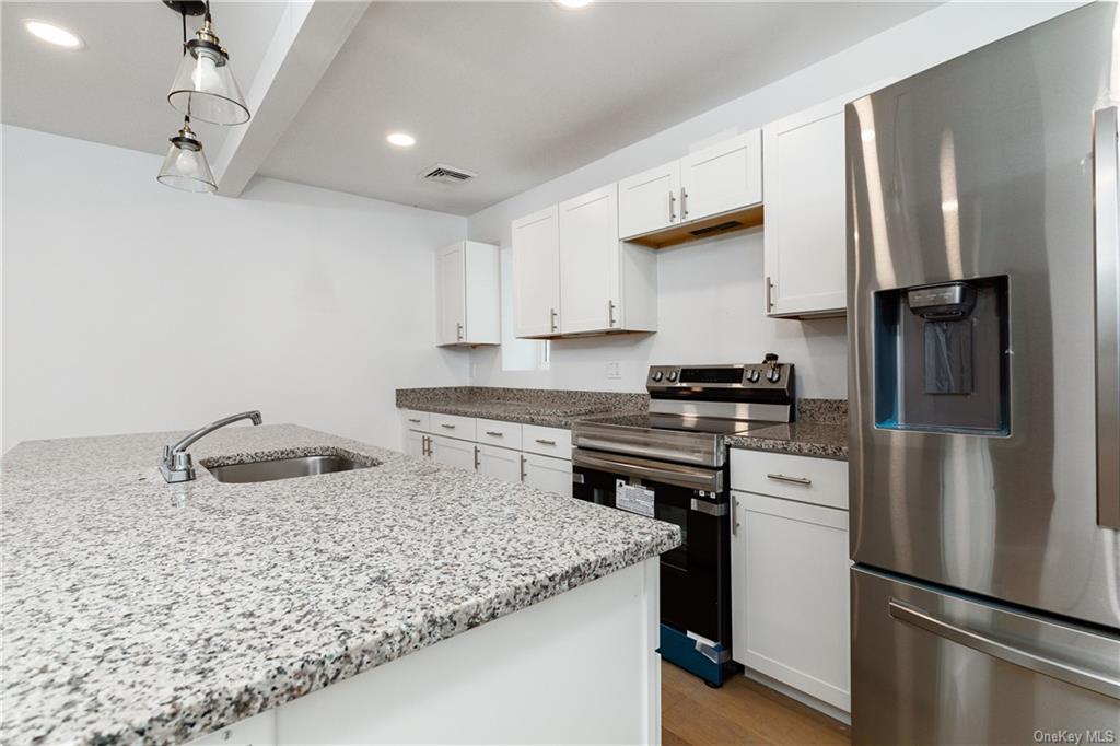 a kitchen with a refrigerator and a sink