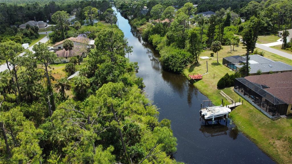 an aerial view of a house with a yard swimming pool outdoor seating