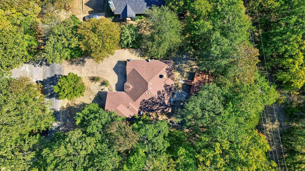 an aerial view of a house with a yard and outdoor seating