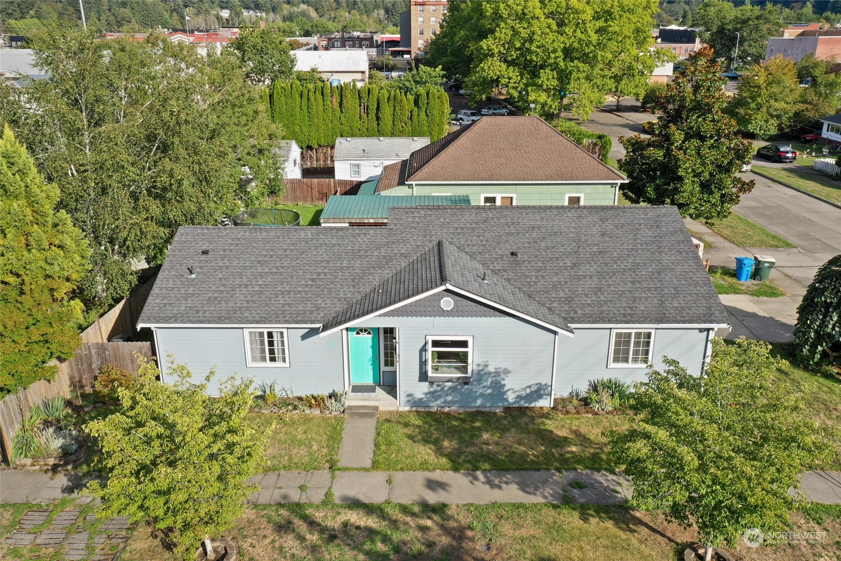 a aerial view of a house next to a yard