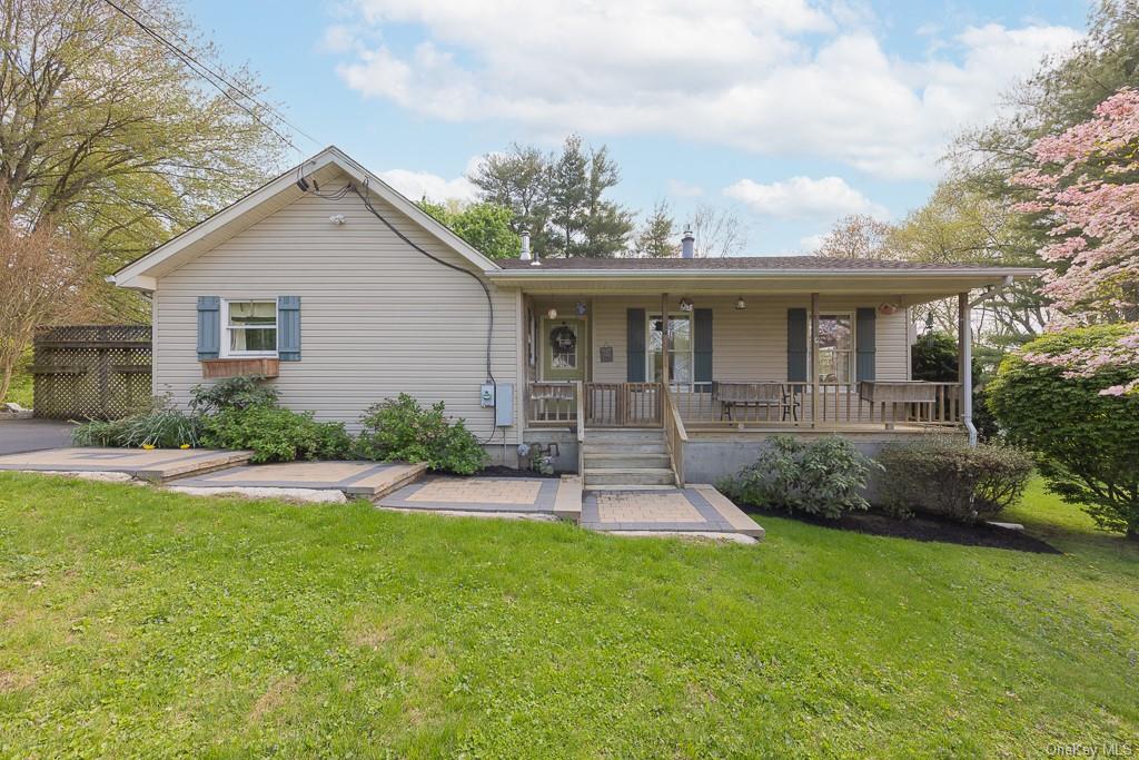 a front view of house with yard and green space