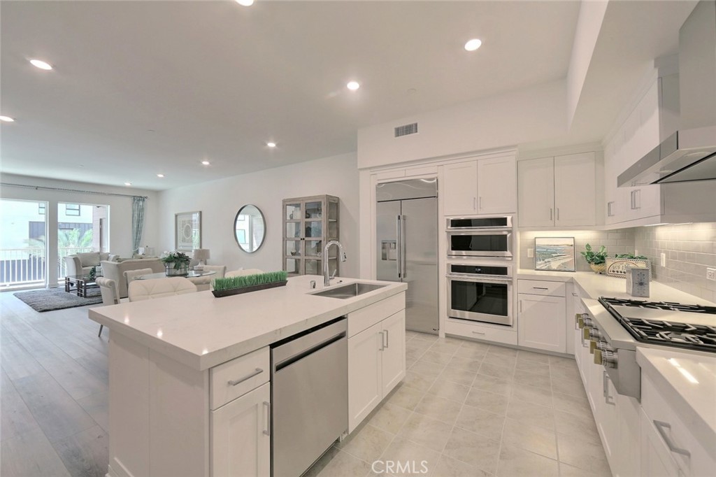 a kitchen with a stove a sink and a refrigerator