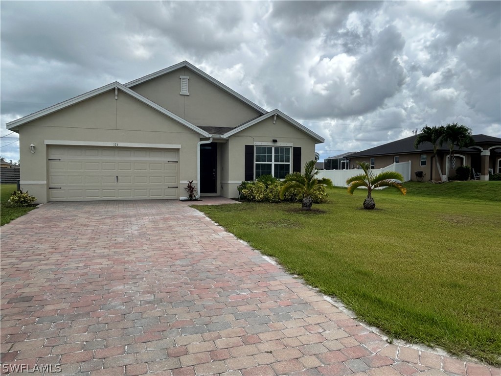 a front view of house with yard and green space